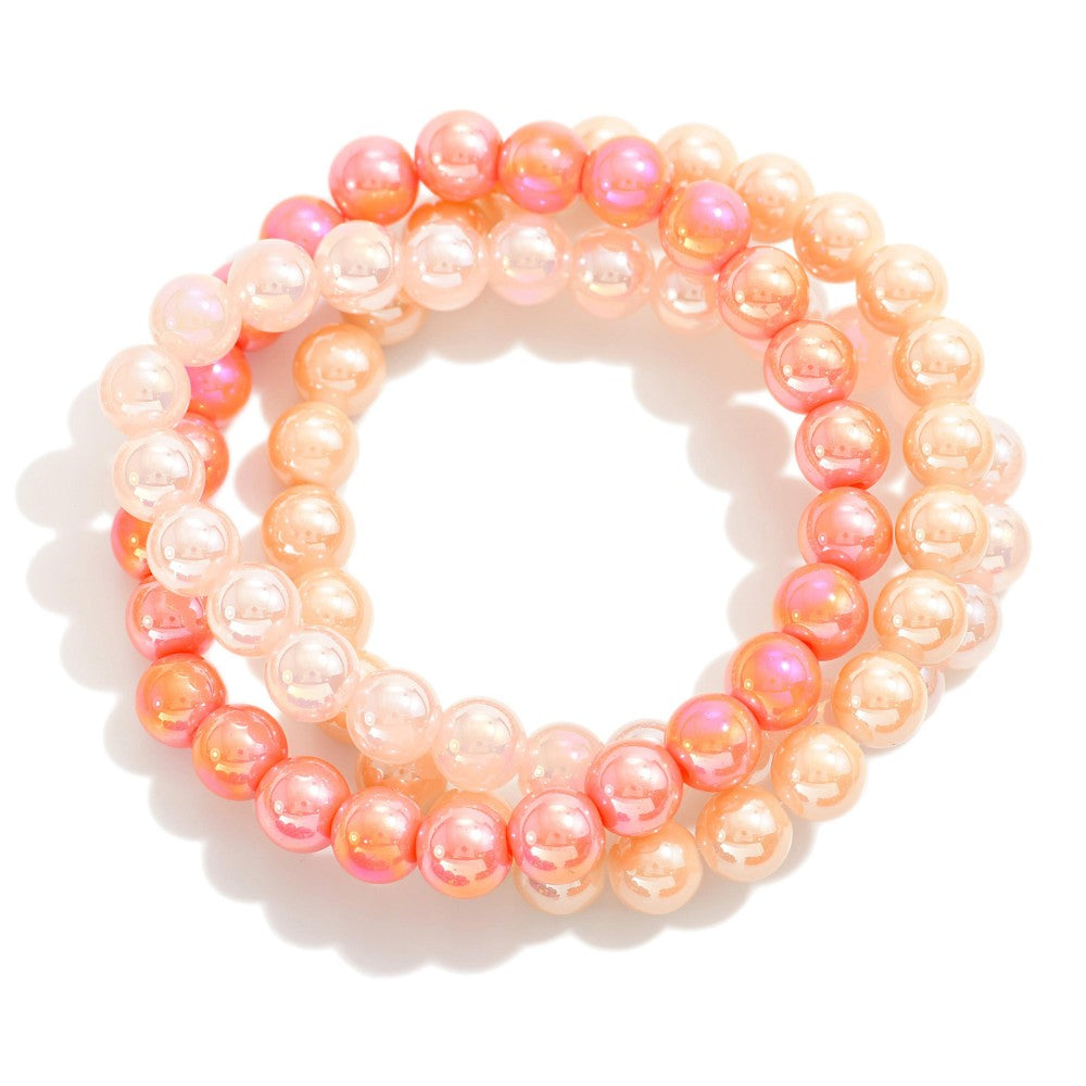 Golden Hour Bracelet Set displayed on white background — set of three pearlescent ombré beaded stretch bracelets in soft neutral, coral, and champagne tones from Anabelle+Oak, high-quality jewelry for spring, summer, and fall styling.