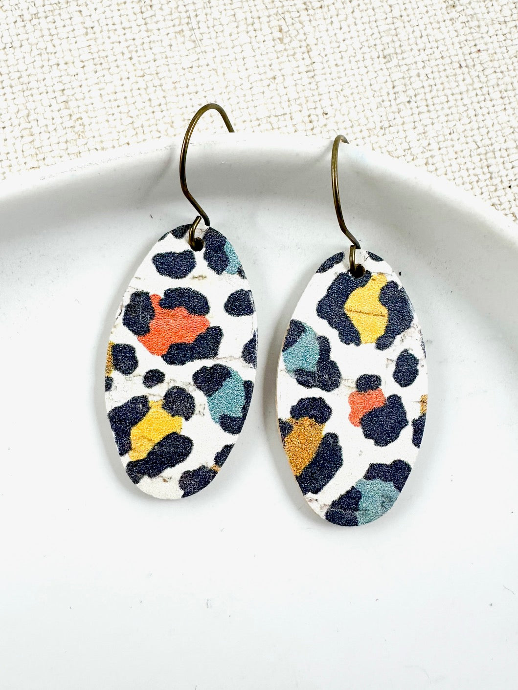 Handmade leather earrings with multicolor leopard print and brass hooks, 1.5-inch drop