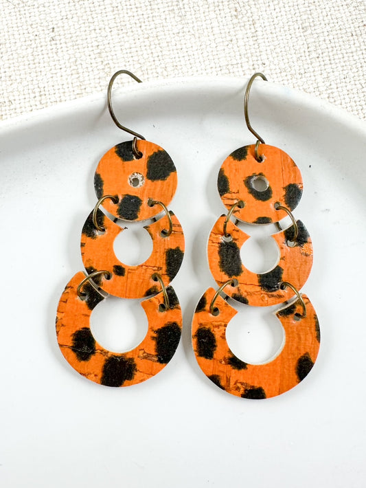 Handmade 2-inch burnt orange animal print leather and cork earrings with black cheetah spots