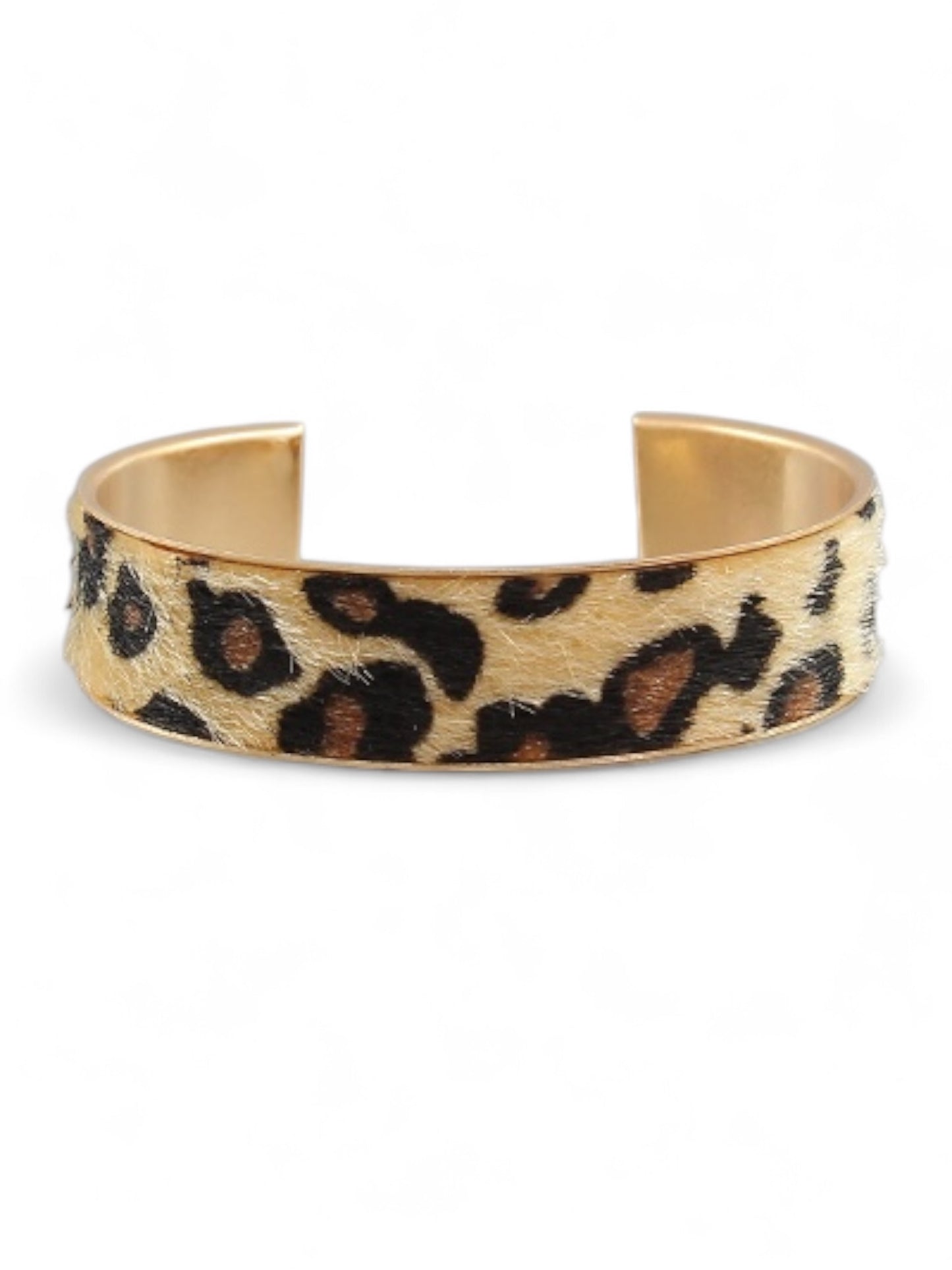 Gold cuff bracelet with soft animal print detailing, shown against white background