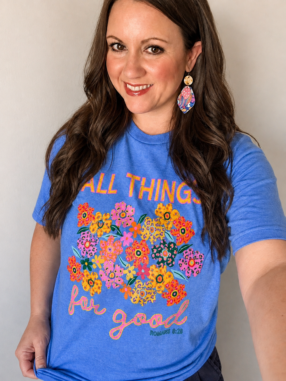 Something Good colorful statement earrings worn with the blue All Things for Good Romans 8:28 graphic tee