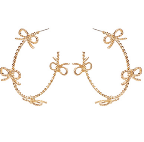 Close-up of gold hoop earrings with multiple small bow shapes on a white background