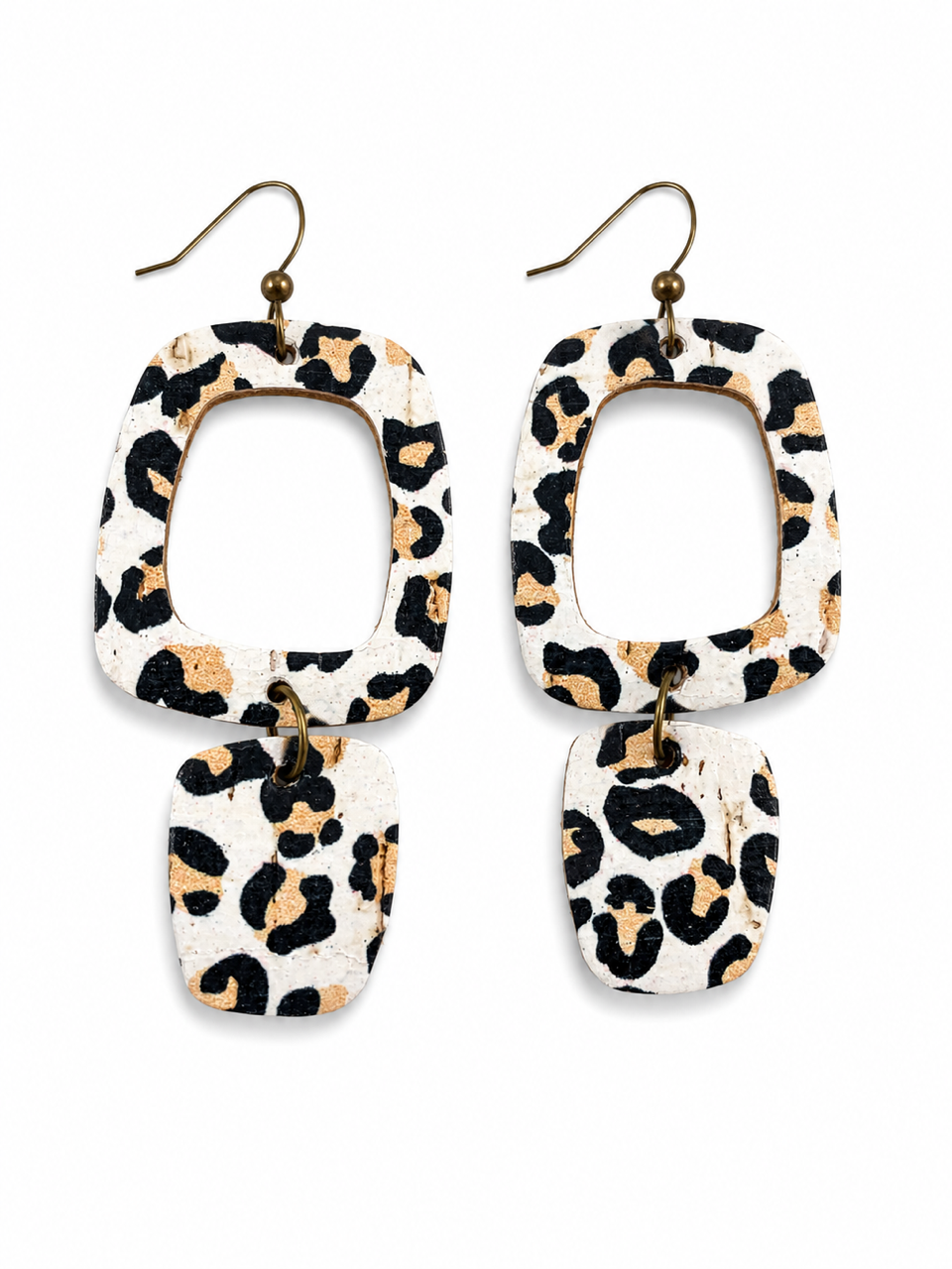 White leopard cork and genuine leather earrings with antique brass hooks on a white background.