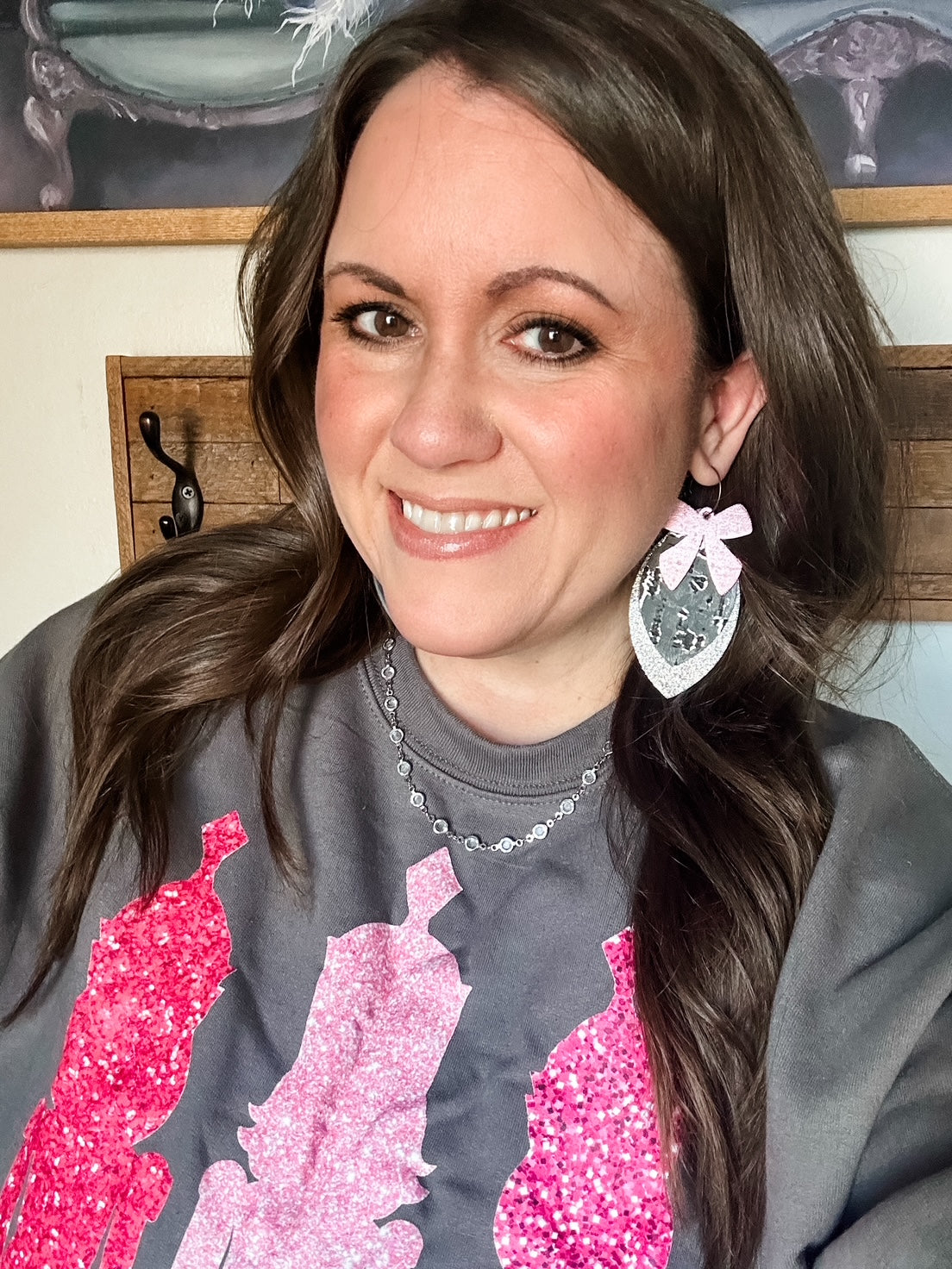 oman wearing Frosted Nutcracker Sweatshirt, charcoal Gildan crewneck with pink faux-sequin nutcrackers, styled for the holidays