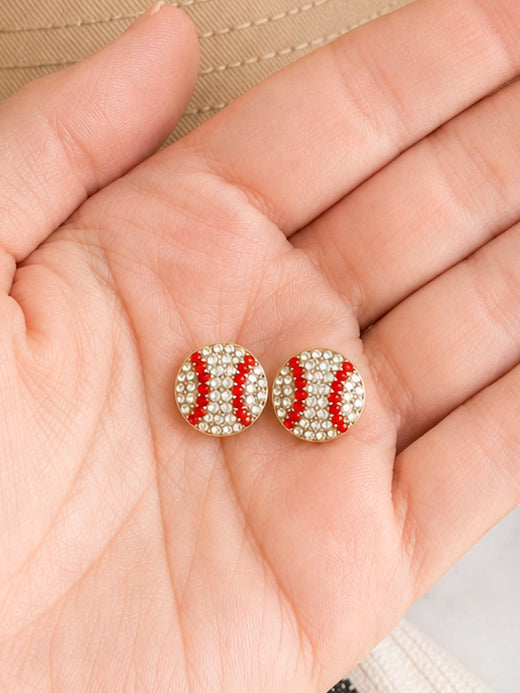 Hand holding Rhinestone Rally Studs to show the true size of the baseball and softball stud earrings.