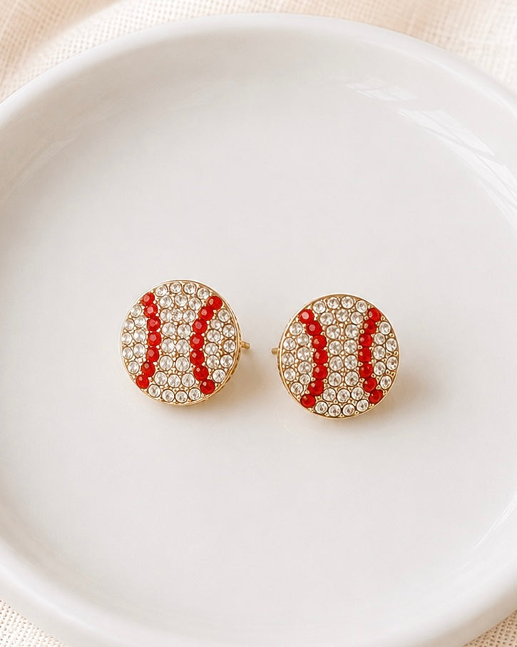 Rhinestone Rally Studs baseball and softball stud earrings with clear rhinestones and red stitching details displayed in a white ceramic dish.