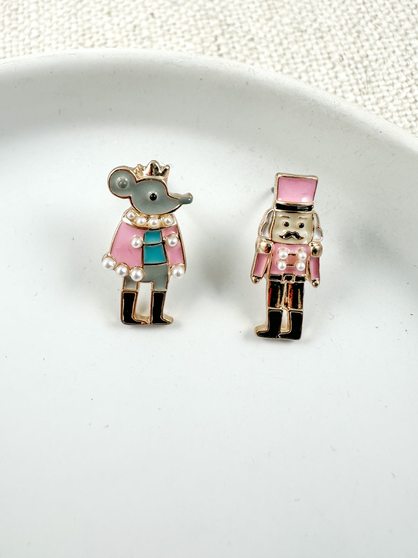 pink mismatched nutcracker and mouse Christmas stud earrings with enamel and pearl accents