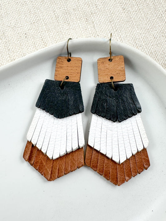 Birch Trail Earrings — handmade genuine leather layered earrings in black, white, and saddle brown with fringe texture, 3-inch drop.