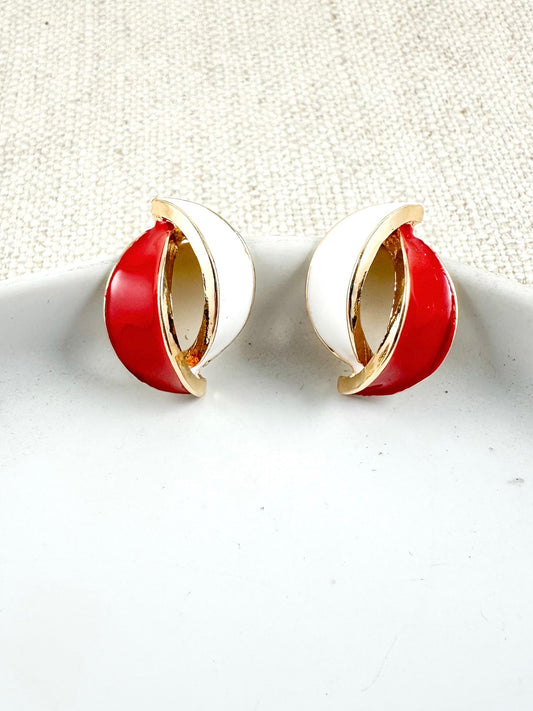 Red and white arc stud earrings with gold-tone trim on a light background