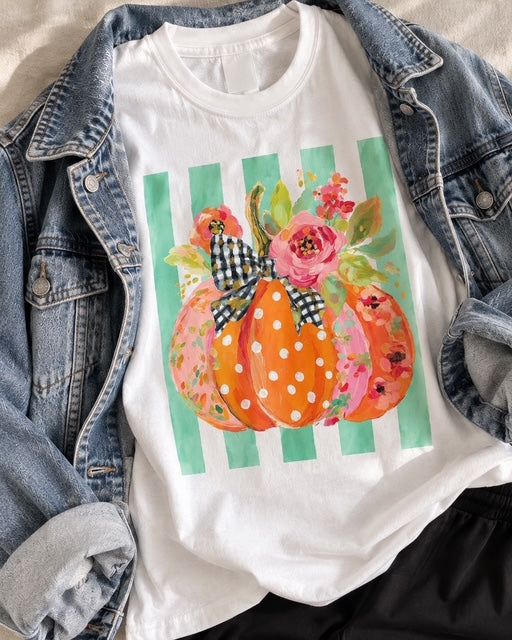 White Comfort Colors floral pumpkin tee with pink, orange and aqua details styled in a boutique fall flatlay