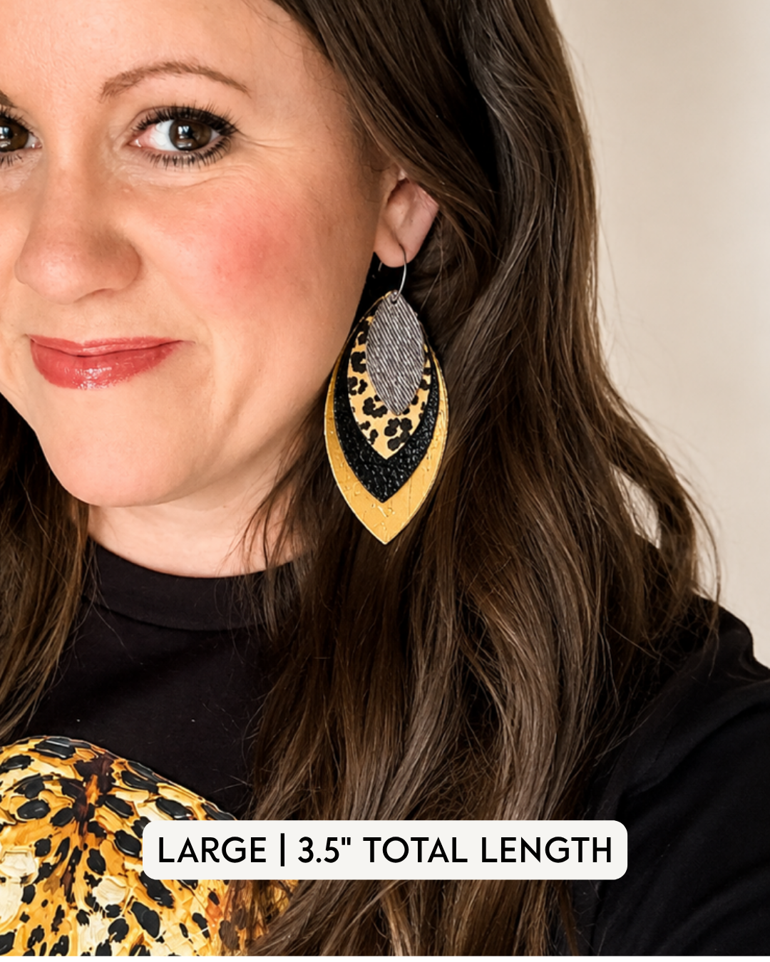 Large layered leopard, black and gold statement earring modeled to show the 3.5-inch length and scale when worn.