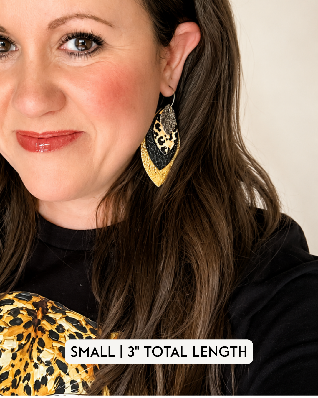 Small layered leopard, black and gold statement earring modeled to show the 3-inch length and scale when worn.