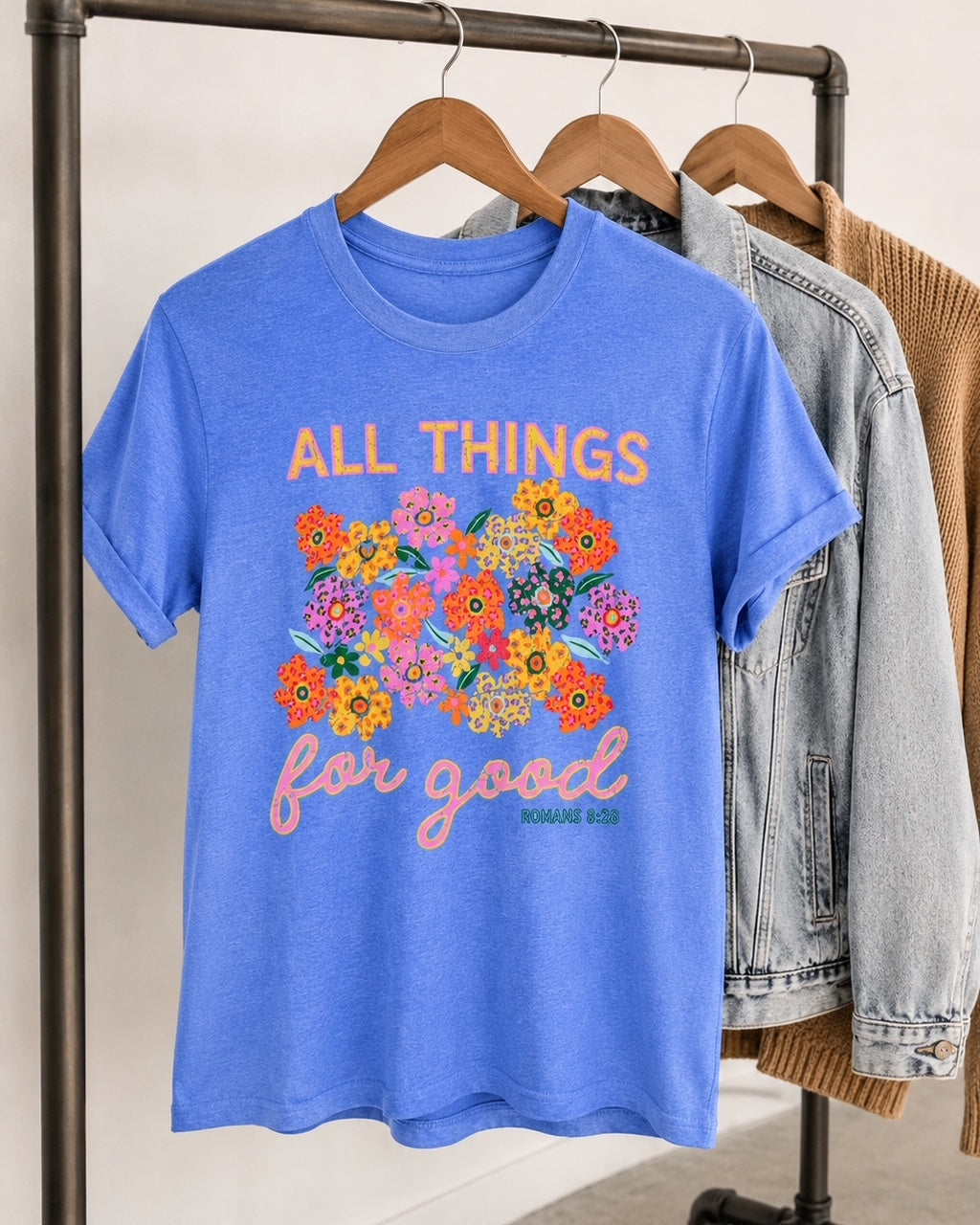All Things for Good Christian graphic tee in Heather Royal styled on a hanger with denim jacket