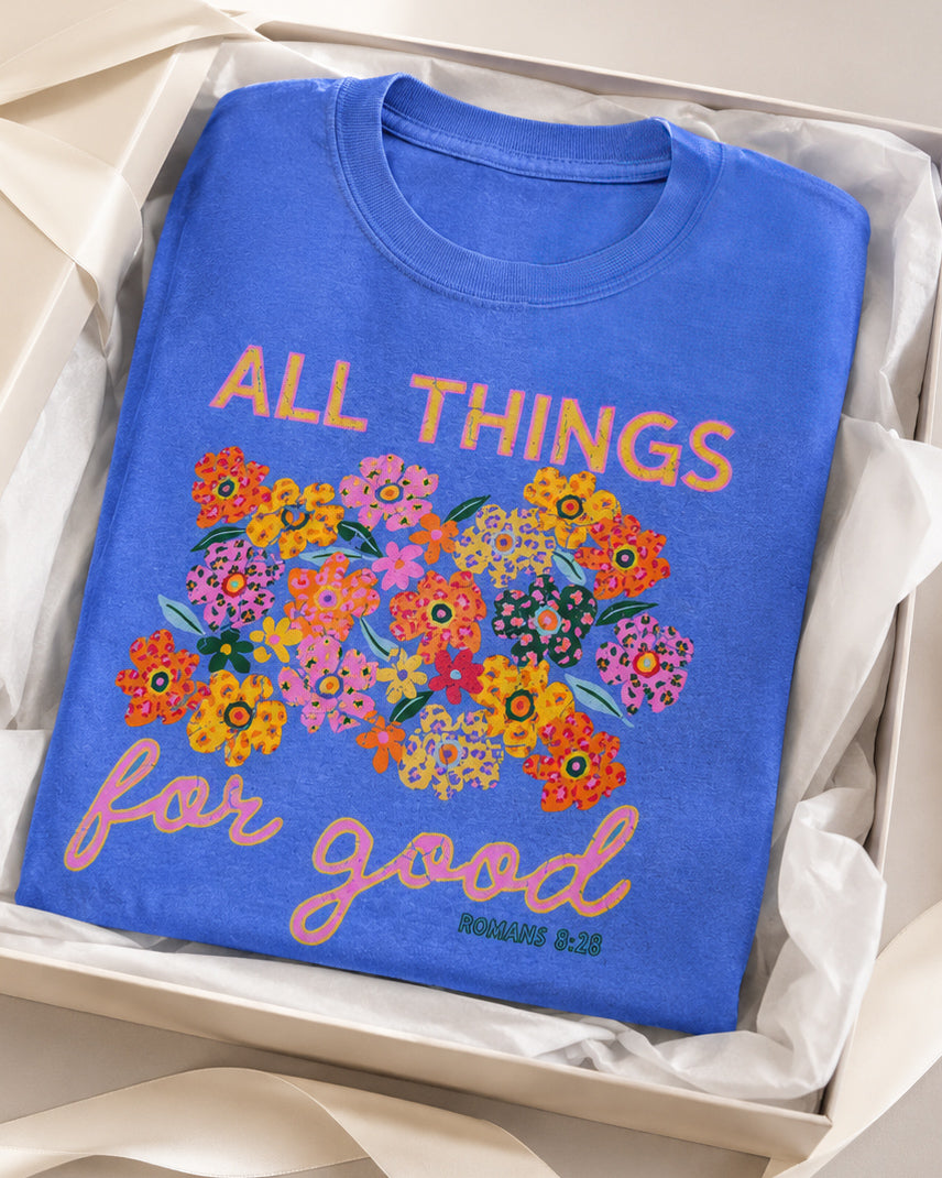 Folded All Things for Good Romans 8:28 tee displayed in a gift box