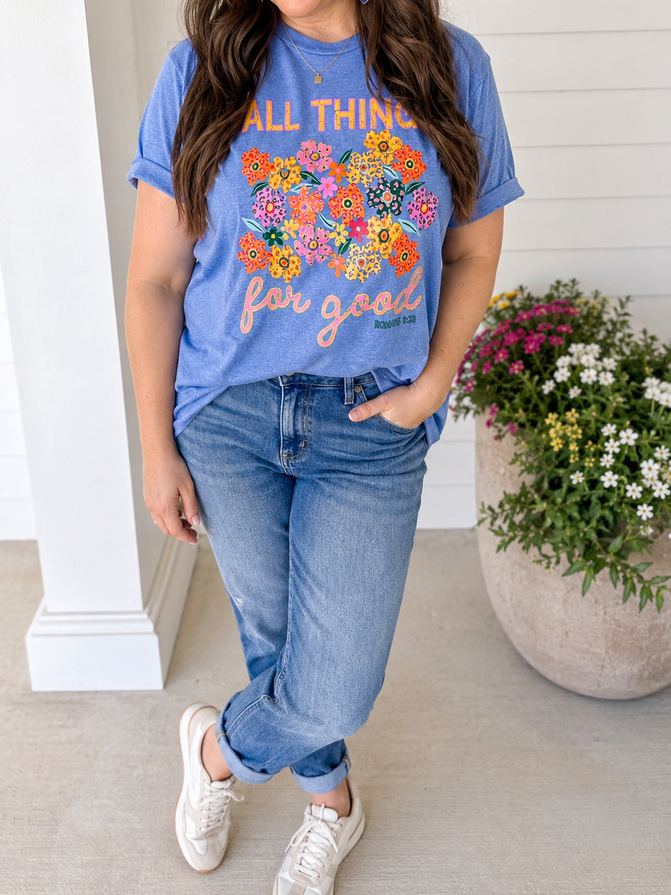 Woman wearing All Things for Good Romans 8:28 floral graphic tee with jeans and sneakers