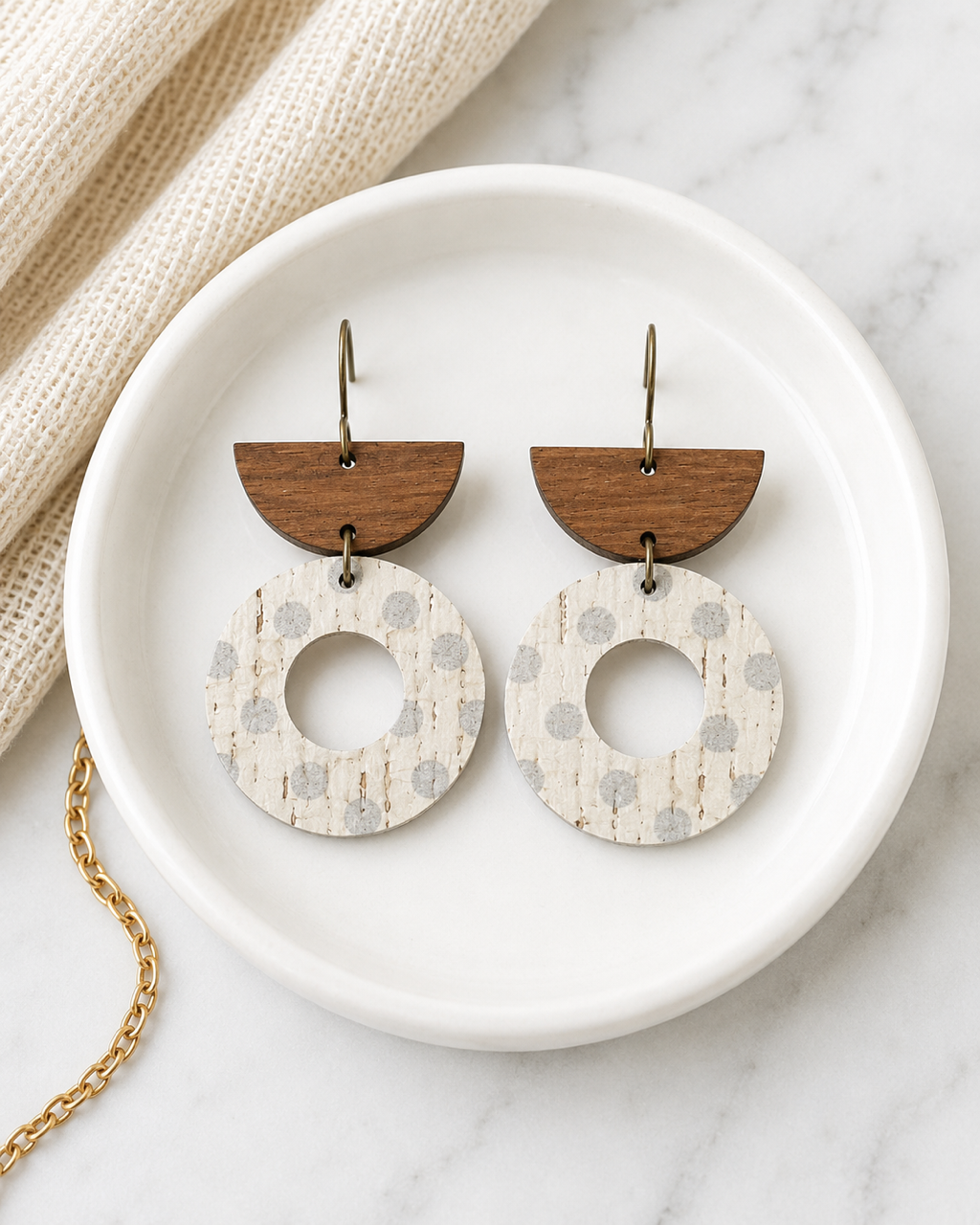 Aspen Mist handmade neutral cork earrings styled on a white ceramic dish.