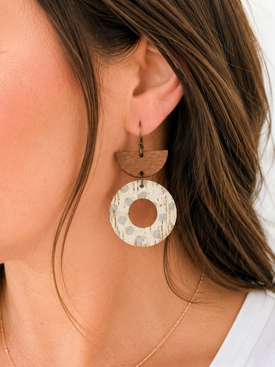 Woman wearing Aspen Mist handmade neutral cork and walnut wood dangle earrings.