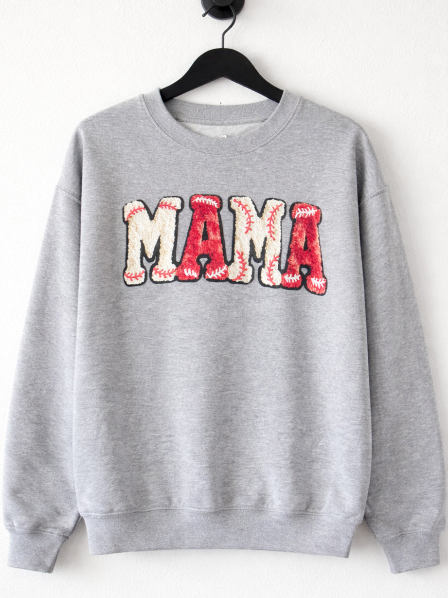 Heather gray crewneck sweatshirt hanging on black hanger with red MAMA varsity graphic and baseball stitch design.