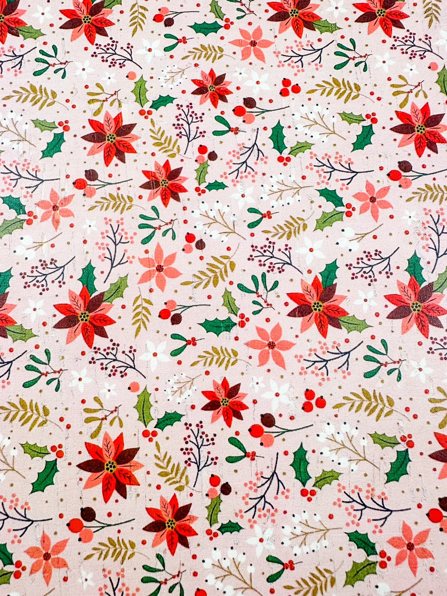 Close-up of Blush Poinsettia Cork featuring pink and red poinsettias, holly, berries, and greenery on a soft blush background.