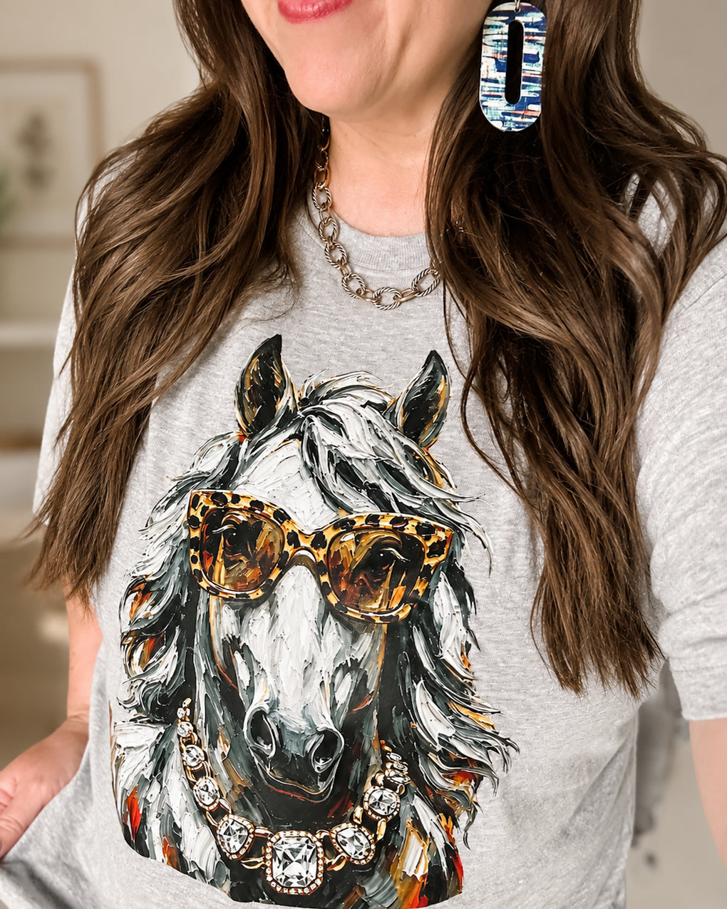 Woman wearing the Bougie Bronco mascot graphic tee in gray