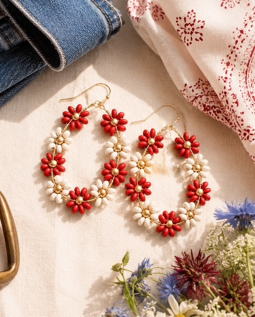 Daisy Lane floral earrings styled with wildflowers and denim on a neutral linen background.