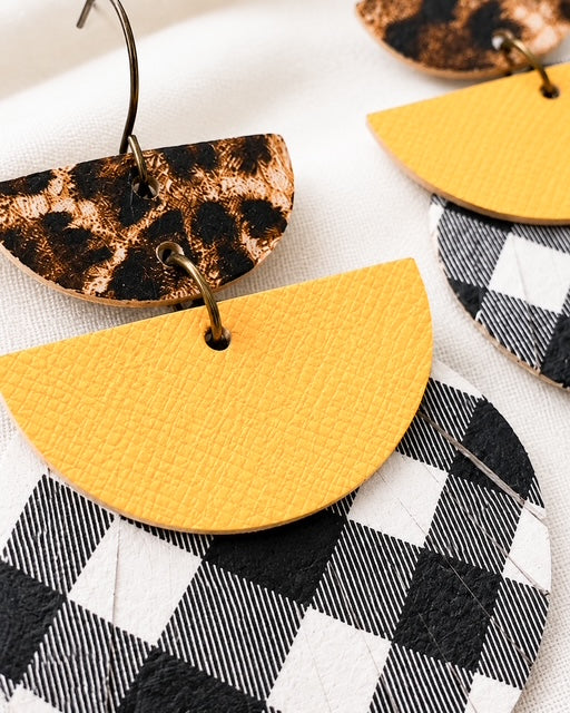 Close-up of the genuine leather prints and linked geometric design of the Dress Code Earrings.