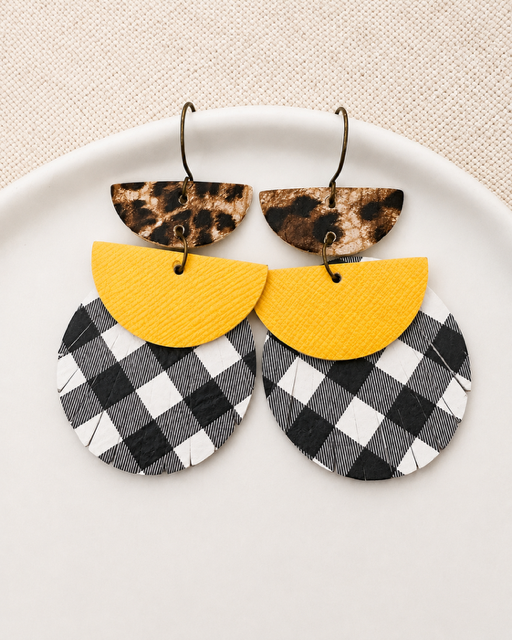 Dress Code Earrings in leopard, yellow, and black-and-white buffalo check displayed in a white dish.