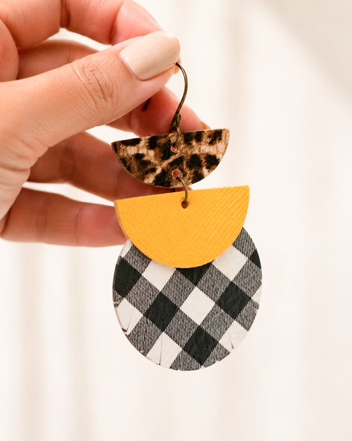 Hand holding one 3-inch Dress Code Earring to show its size and shape