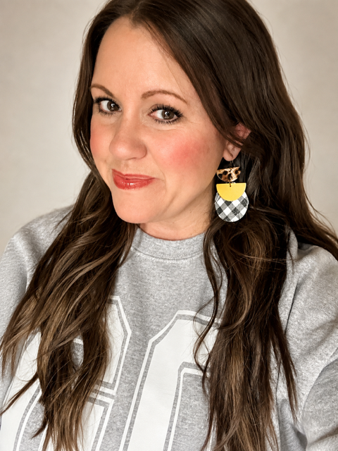 Woman wearing the 3-inch Dress Code Earrings with the coordinating Friday Uniform Shirt.