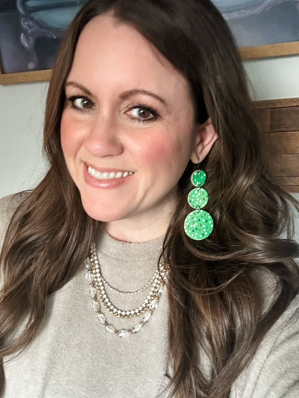 Woman wearing Evergreen Confetti Cork circle dangle earrings in a three-tier design