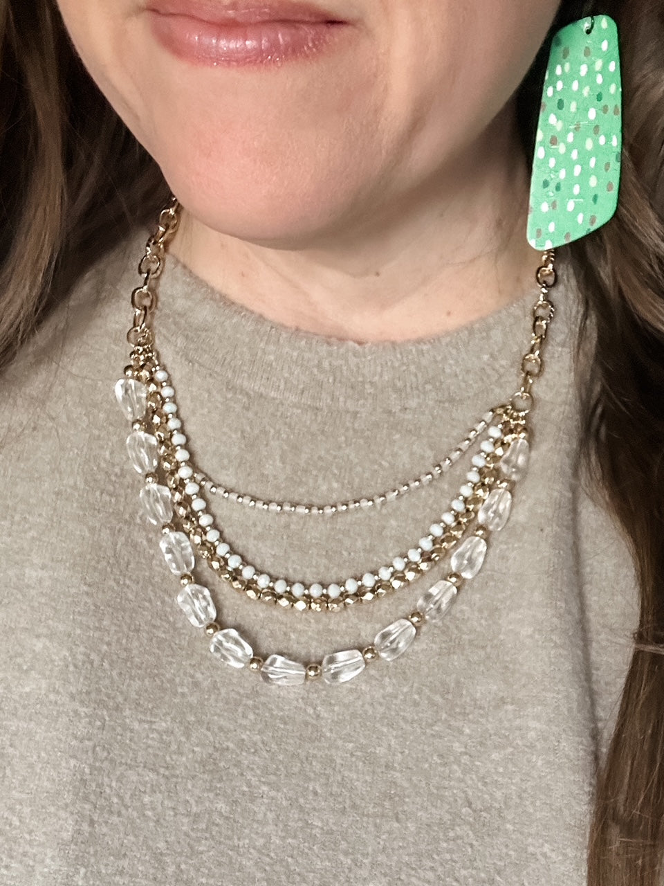 Evergreen Confetti Cork long geometric earring paired with layered neutral necklace
