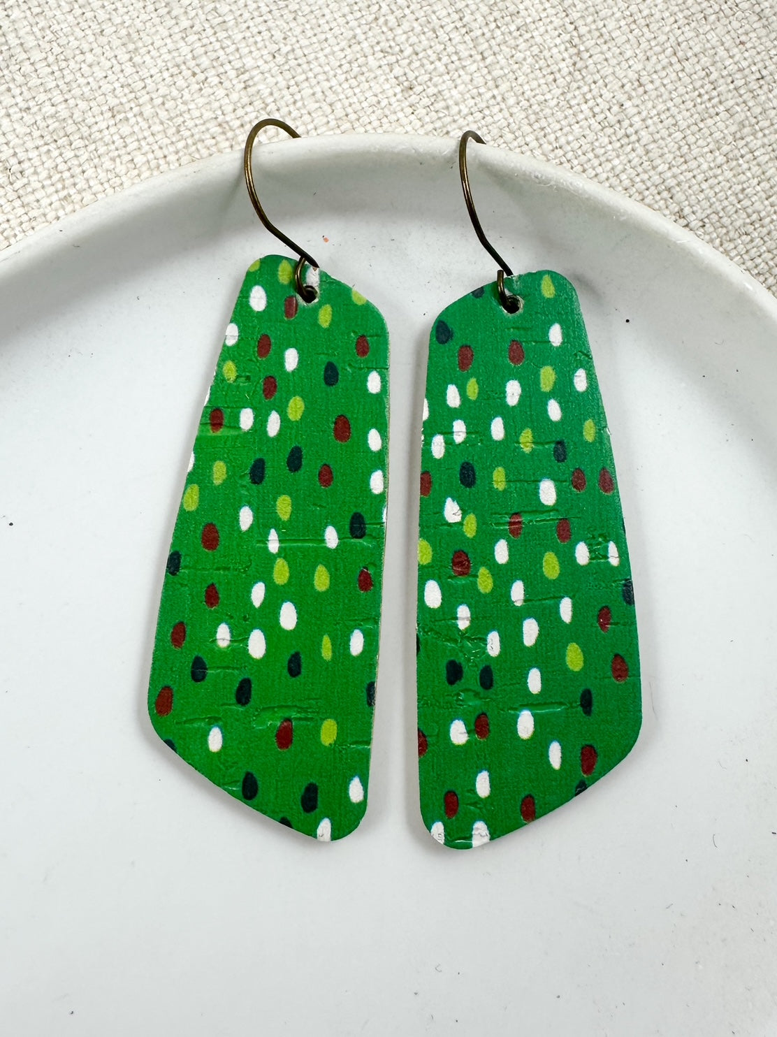 Evergreen Confetti Cork long geometric earrings on white plate