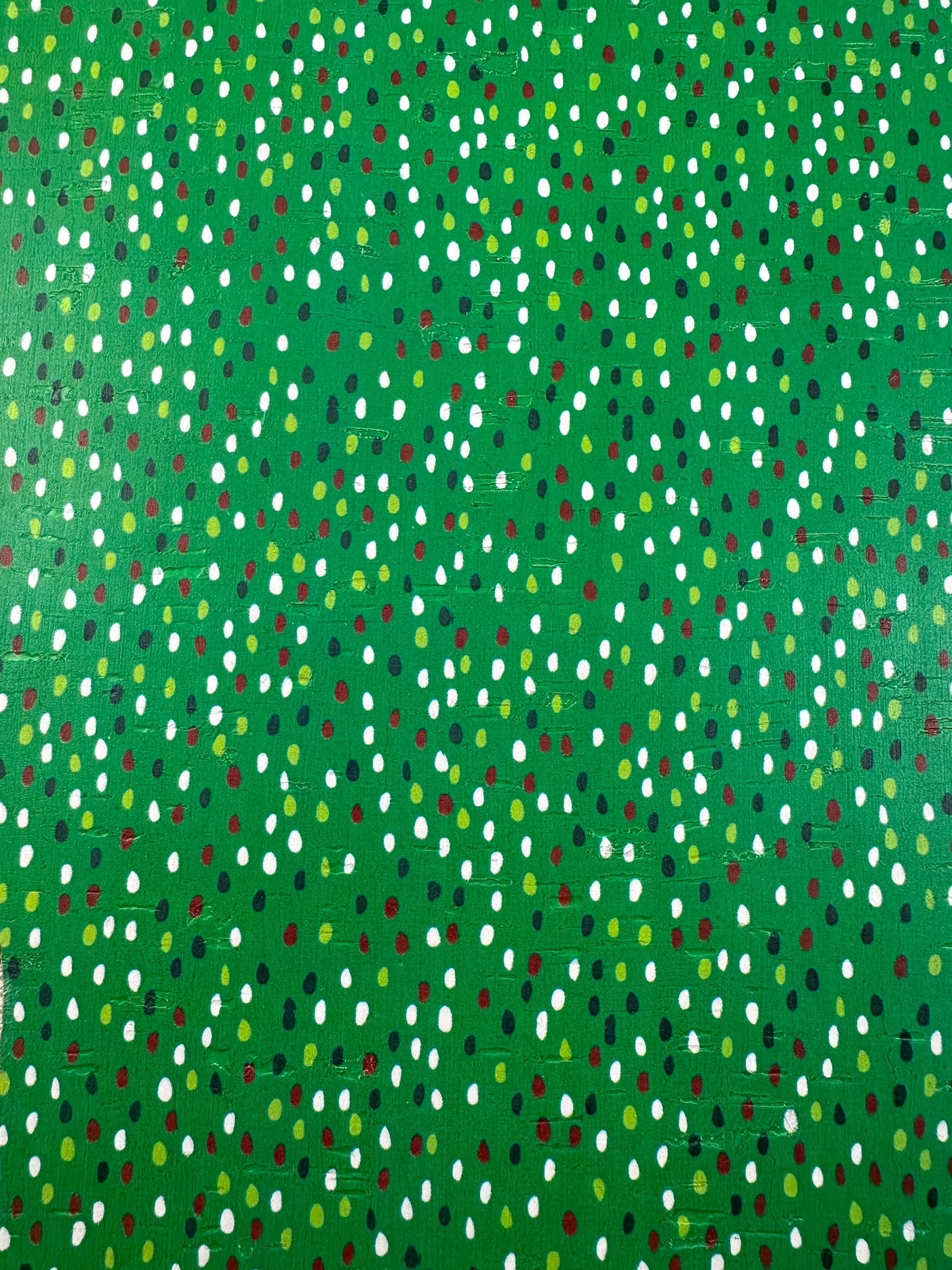 Evergreen Confetti Cork closeup showing green background with red white and gold dots
