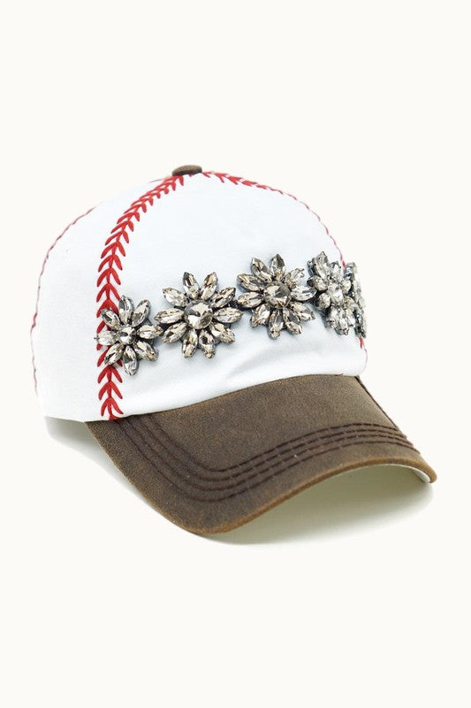 White baseball cap with red embroidered stitching, distressed brown bill with worn leather look, and topaz stone embellishment across the front.