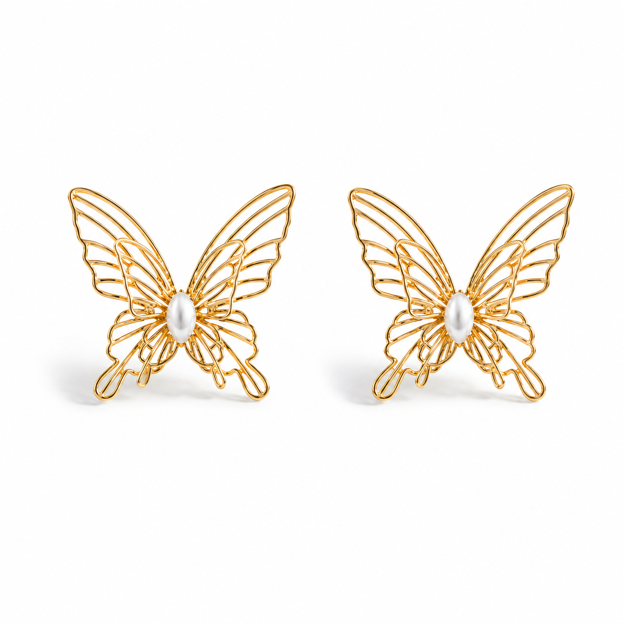 Gold filigree butterfly stud earrings with faux pearl centers on a white background.