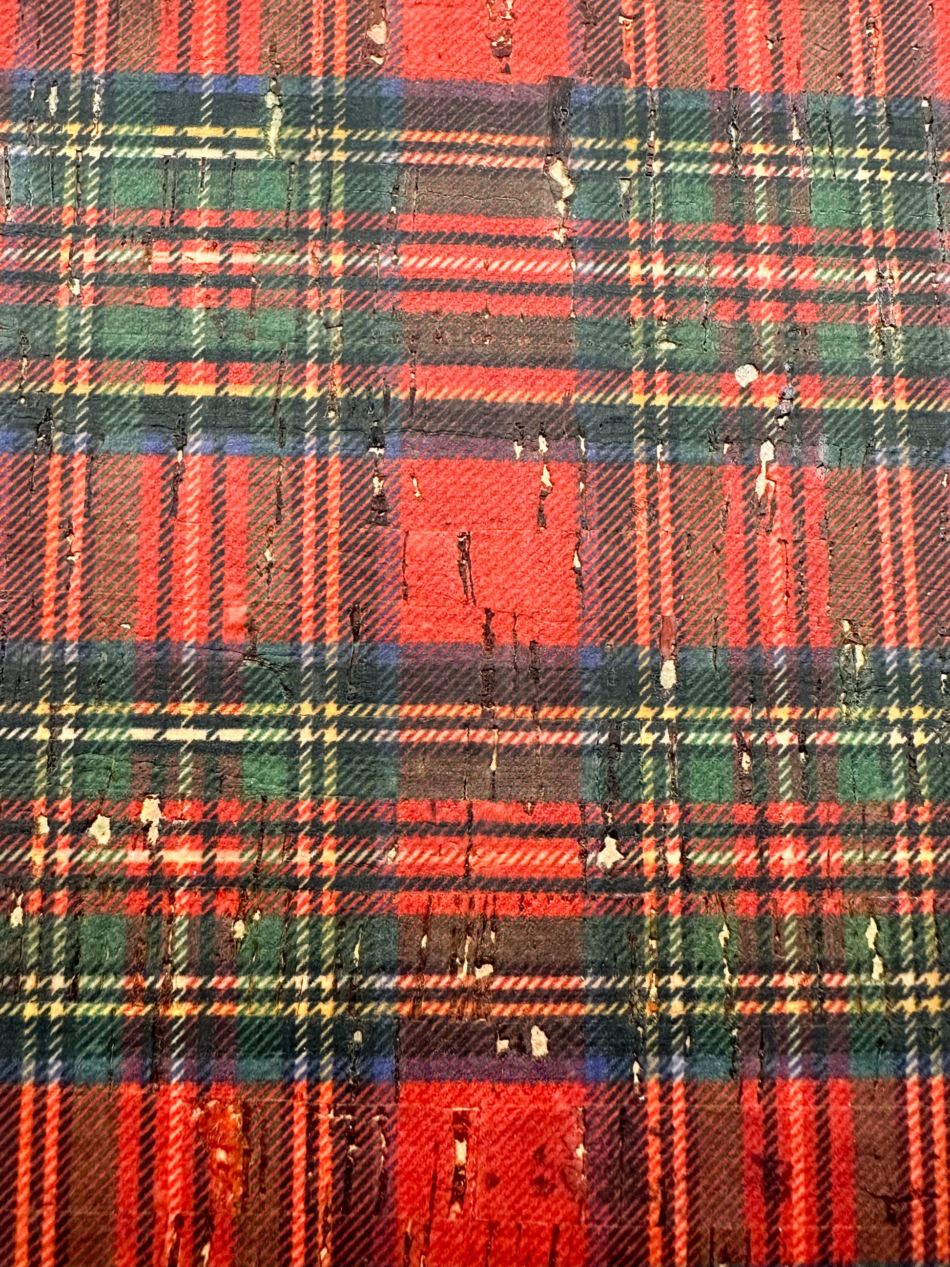 Close-up of Fireside Tartan Plaid cork showing the red, green, navy, and gold holiday plaid pattern with natural cork texture visible throughout.