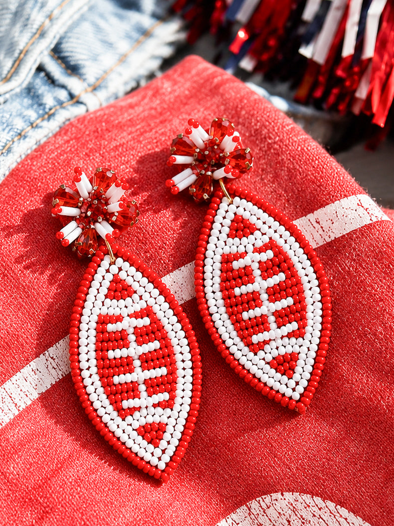 Football & Fireworks red beaded football earrings styled on a red game day shirt
