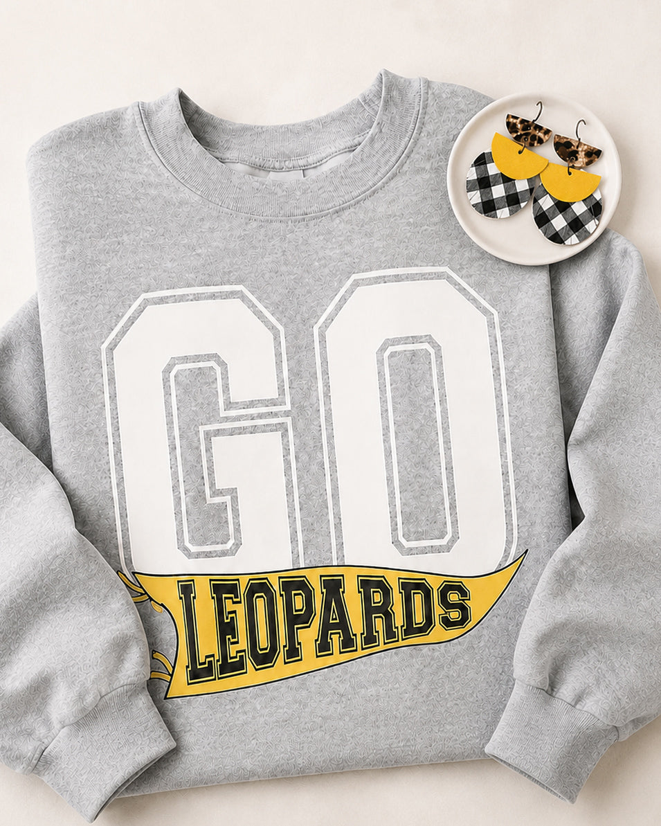 Friday Uniform sweatshirt paired with coordinating black, white, and yellow Dress Code Earrings in a small white dish.