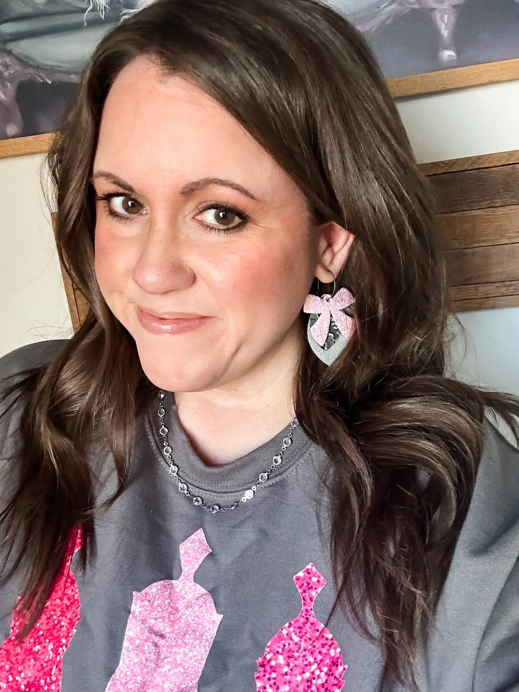 Close-up of charcoal Gildan sweatshirt with three pink faux-sequin nutcrackers, cozy Christmas crewneck from Anabelle+Oak