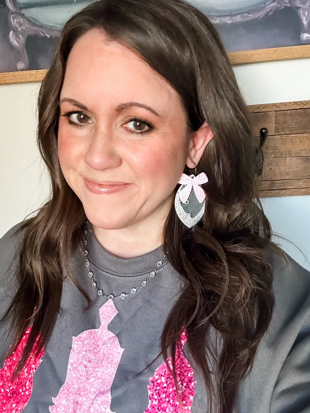 Frosted Nutcracker Sweatshirt modeled with pink bow earrings, cozy holiday outfit from Anabelle+Oak