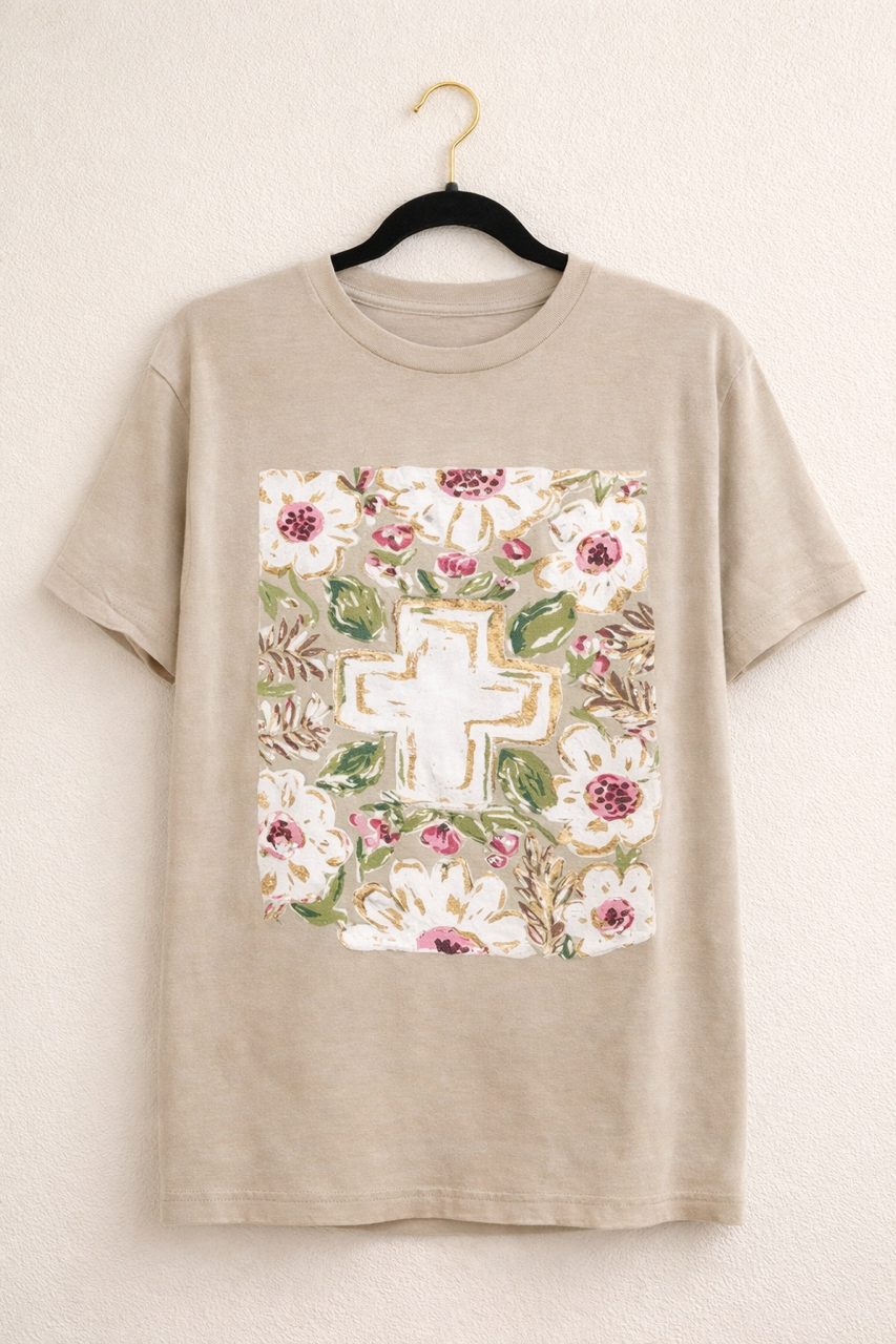 Heather tan Bella Canvas short sleeve Christian graphic tee hanging on a black hanger with a floral cross design on the front.