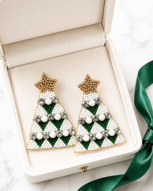 Green beaded Christmas tree earrings displayed inside an ivory jewelry gift box