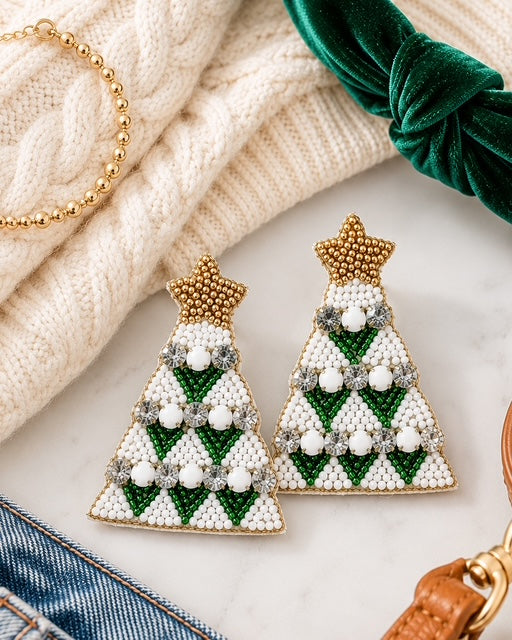 Green Christmas tree statement earrings styled with a cream sweater, green velvet headband, and gold accessories