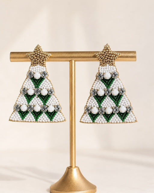 Green beaded Christmas tree statement earrings displayed on a matte gold jewelry stand