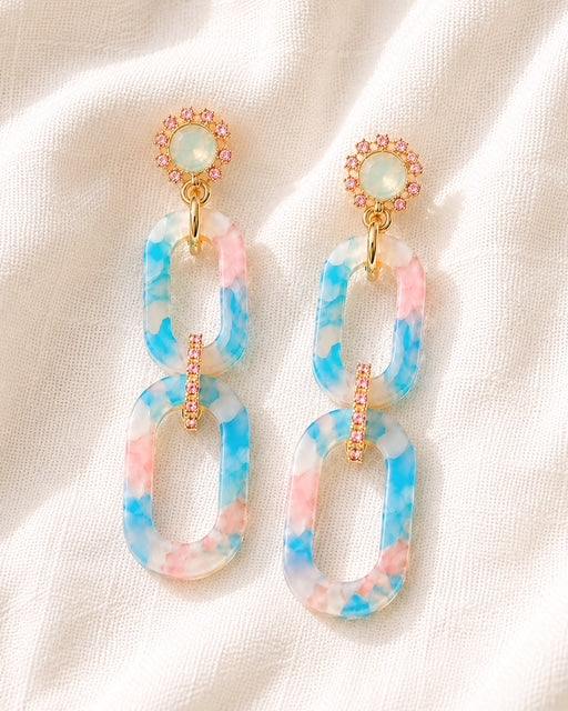 Blue and pink Hampton Drop statement earrings featuring marbled acrylic links, iridescent opal-like studs, and delicate gold detailing.