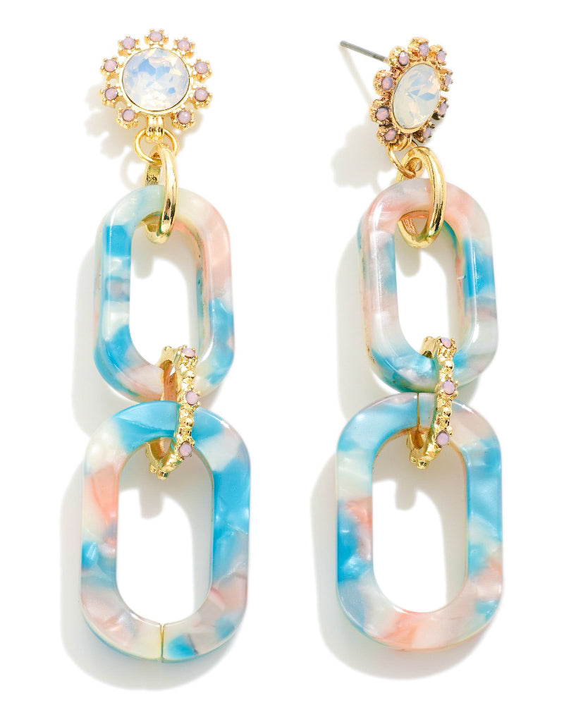 Front and side views of Hampton Drop Earrings featuring blue and pink marbled acrylic links, iridescent opal-like studs, pink crystal accents, and gold detailing.