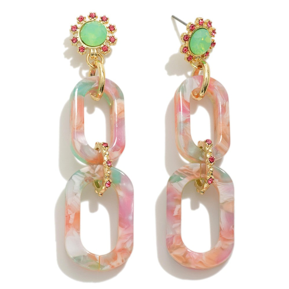Close-up detail of Hampton Drop Earrings showing marbled acrylic links, gold-tone hardware, and pink rhinestone accents.