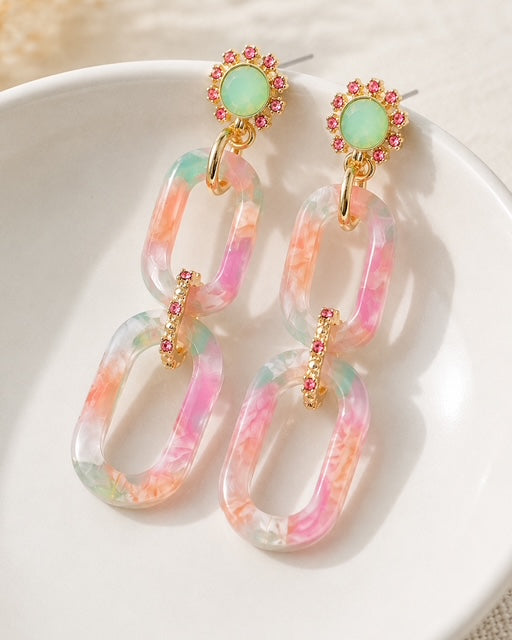 Hampton Drop Earrings styled in a white ceramic jewelry dish featuring marbled pink and green acrylic links.