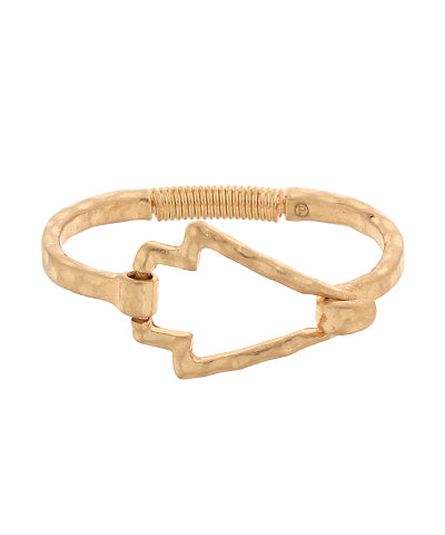 worn gold hammered metal bracelet with open arrow shape displayed on white background