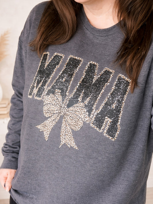 Woman wearing charcoal MAMA graphic sweatshirt with faux sequin style lettering and leopard bow detail.